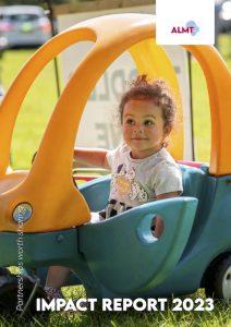 Girl in toy tractor courtesy of Restore Hope